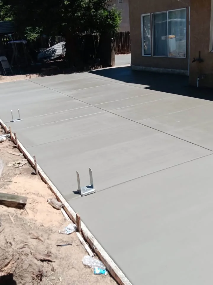 New concrete slab along the side of a residence