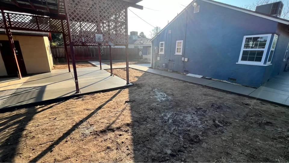 Backyard area measured and prepared for a concrete and landscape layout