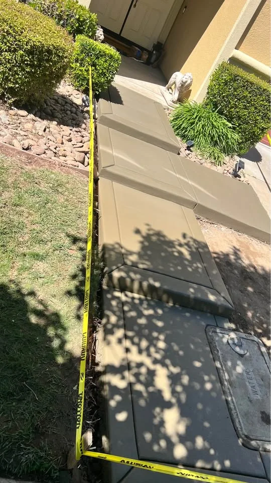 Concrete front walkway leading directly to a home entrance