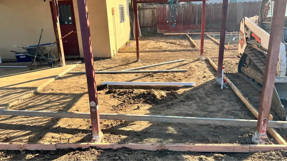 Wood forms and reinforcement laid out for a backyard patio